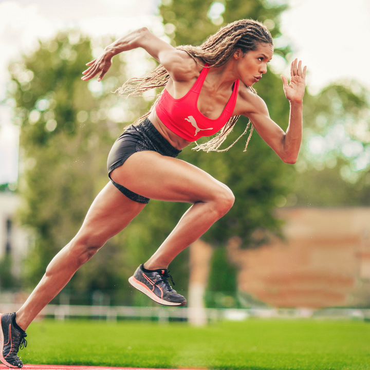 Runner accelerating on a track outdoors