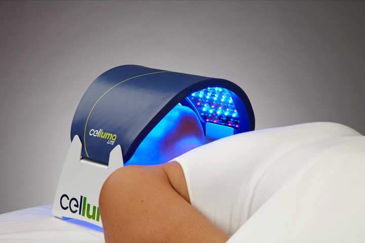 Blue Celluma panel positioned over a reclining woman's face