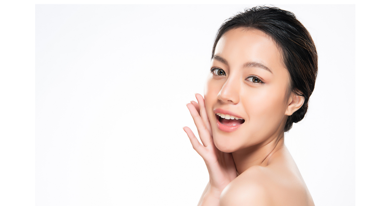 Woman touching her cheek against a white background