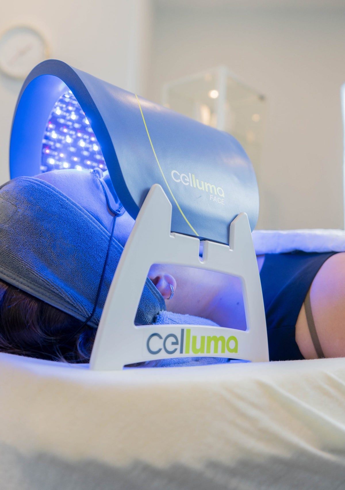 Blue-lit Celluma panel supported above a treatment bed