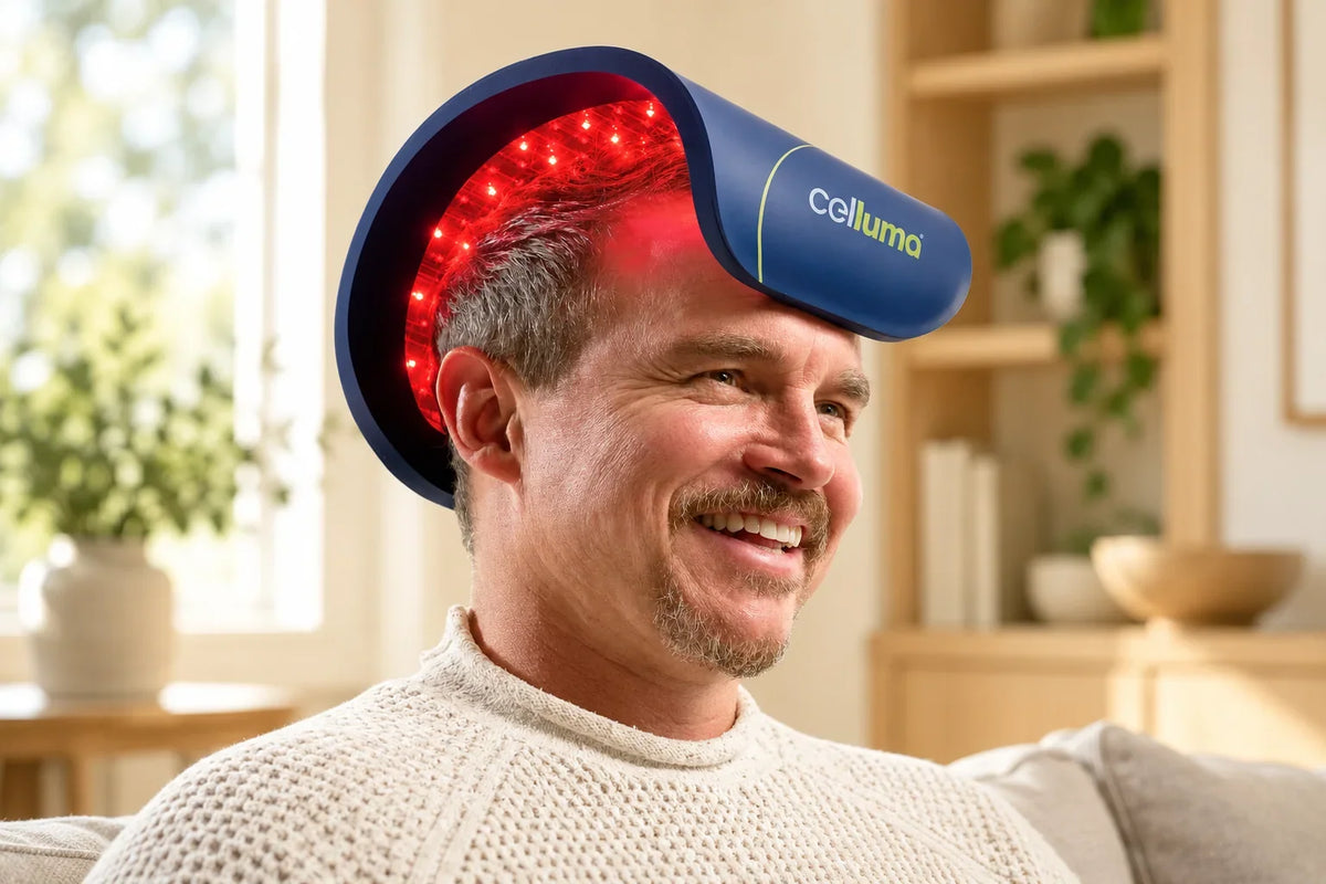 Man using a flexible Celluma red light therapy panel over his scalp