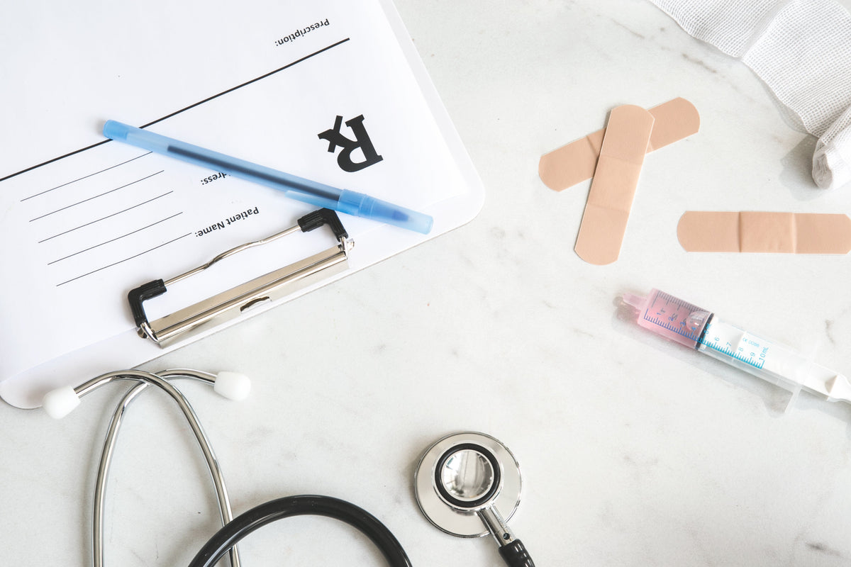Medical instruments and a clipboard on a desk