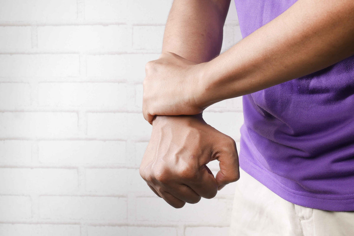 Person holding an irritated forearm