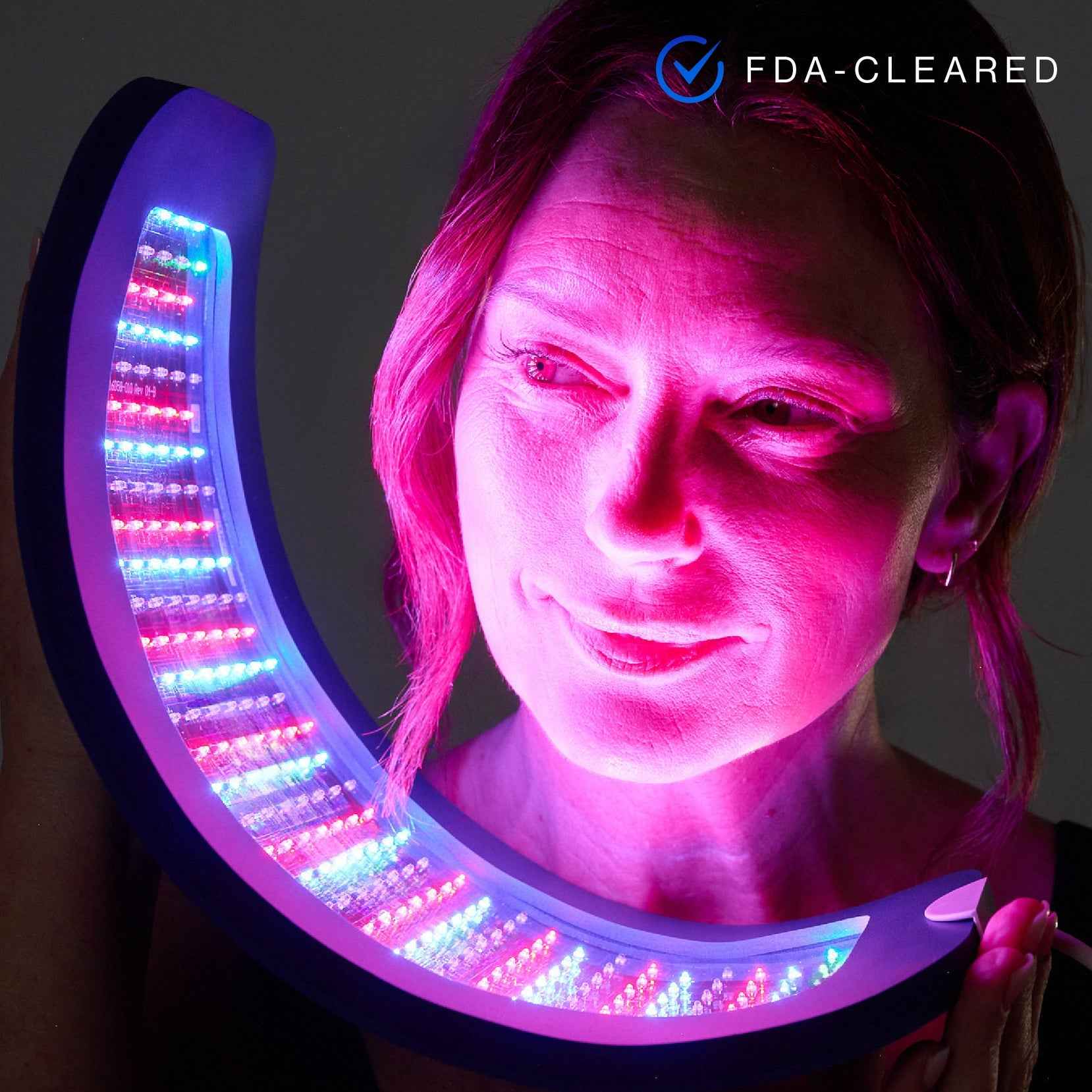 A woman using Celluma Nova led red light therapy for acne treatment.