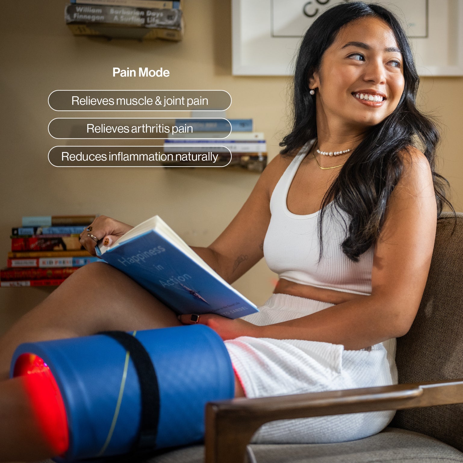 A Celluma PRO LED light therapy panel in a flexible, curved position over a person's back. The device is emitting a bright blue and red medicinal glow for pain relief treatment in a clean, modern wellness clinic setting