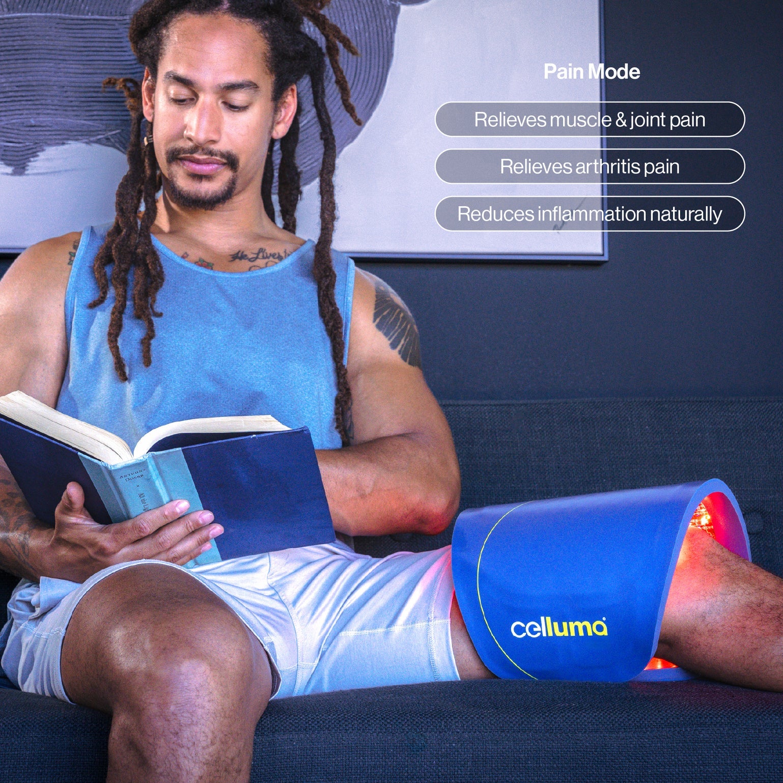 The Celluma PRO PLUS LED panel in 'Pain Mode,' emitting deep-penetrating near-infrared light (880nm). This lifestyle image demonstrates the device contoured to the lower back, showing how it increases circulation and ATP production to relieve joint stiffness, arthritis, and muscle spasms without the need for a power outlet.