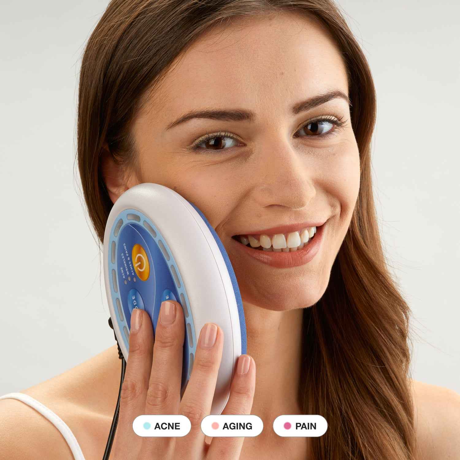 Woman using Celluma POD Ultra-portable LED Red Light Therapy device for skin rejuvenation on her face.