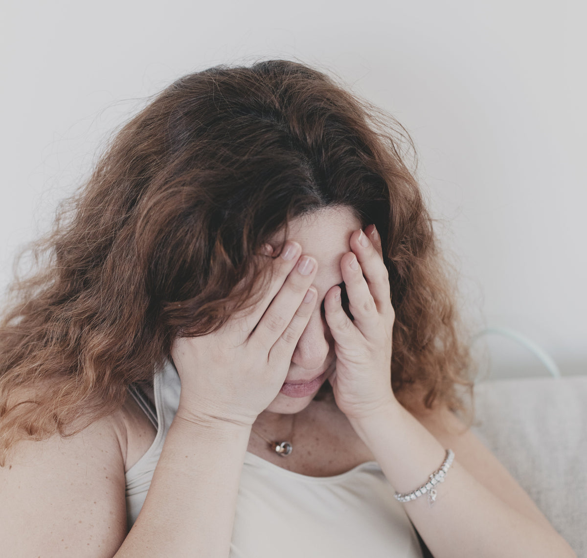 Woman resting her face in her hands