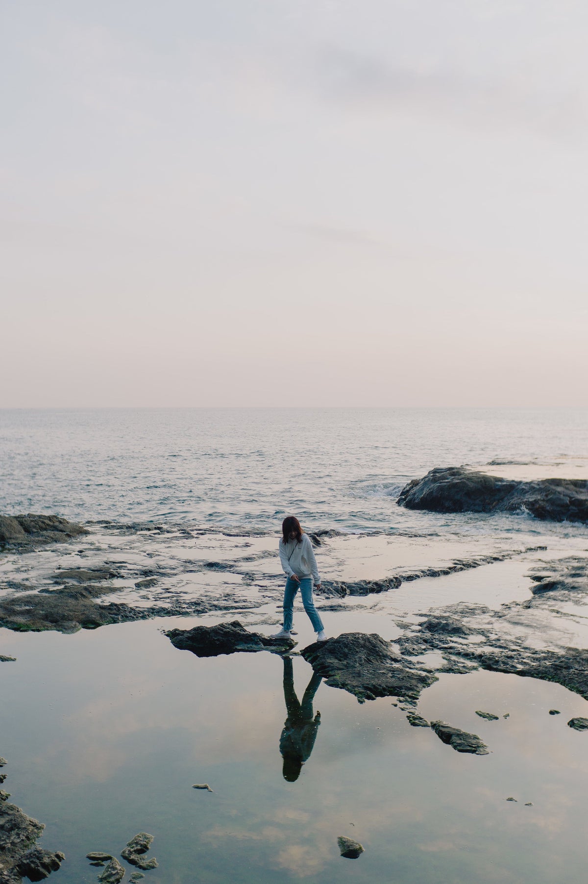 Person walking beside the sea in daylight