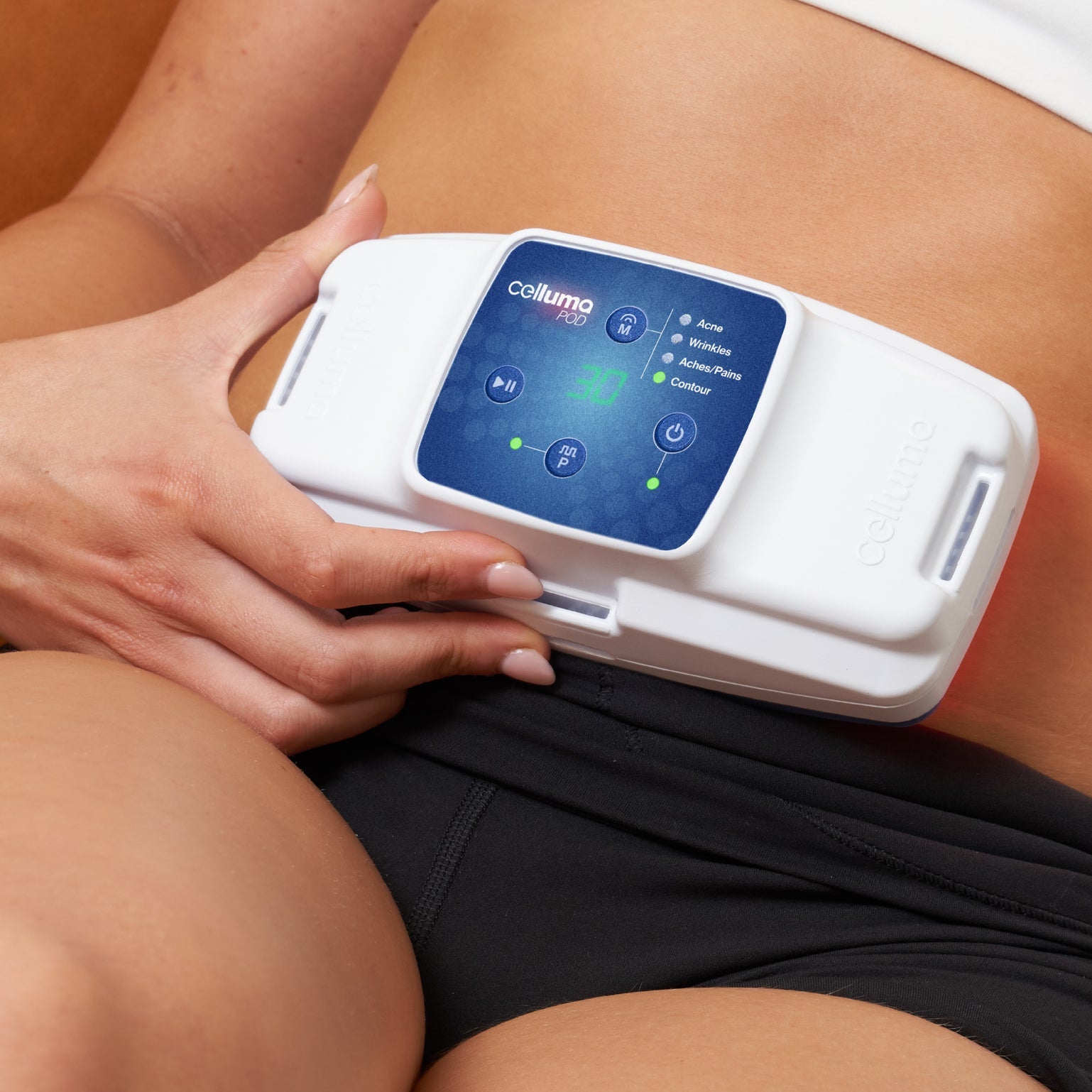 Celluma POD Series 2 in Body Contour mode treating the abdomen. This FDA-cleared handheld LED device uses red (640nm) and near-infrared (880nm) light to make fat cells porous, releasing lipids to naturally slim the waist and midsection.