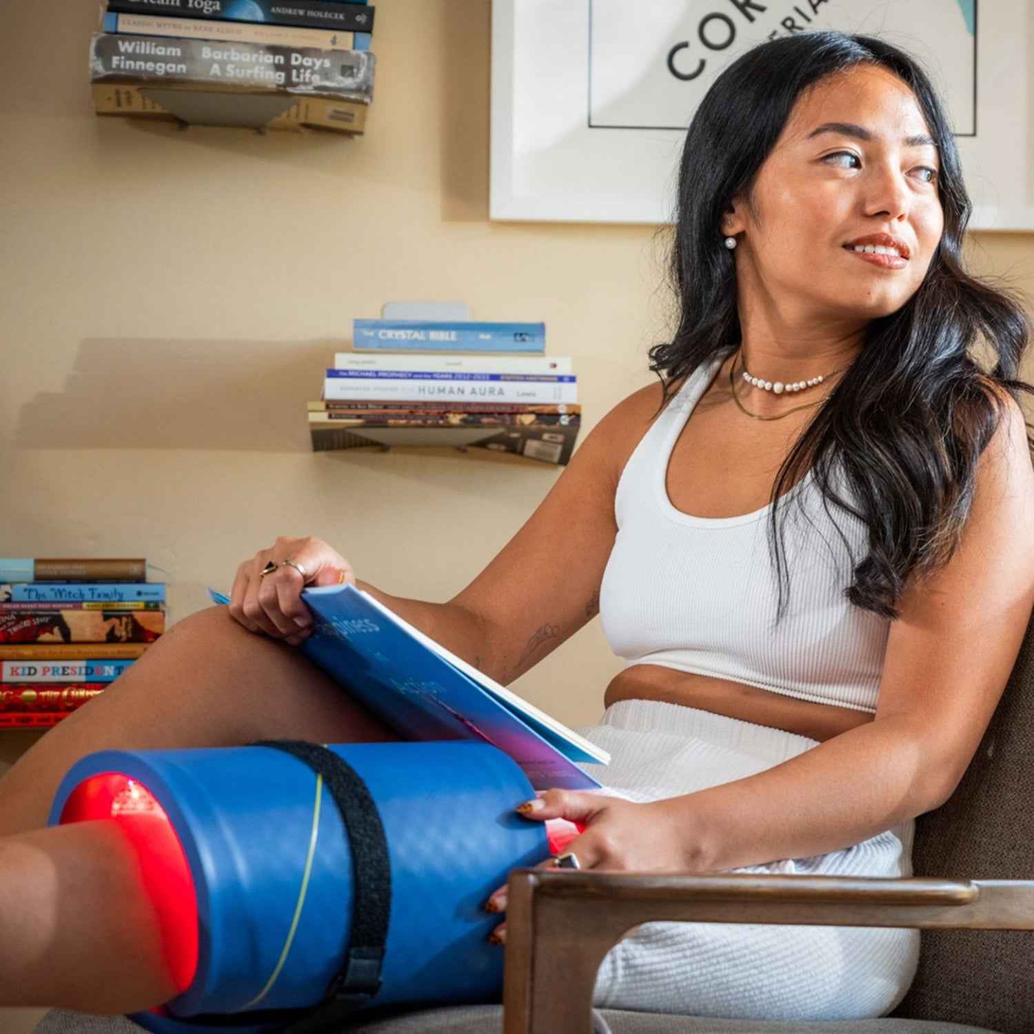 A woman using Velcro strap on her Celluma PRO LED Red light therapy to be handfree.