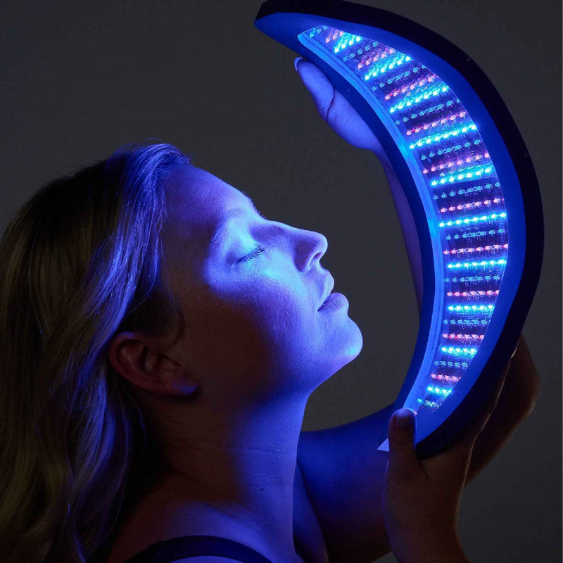 Woman holding a curved Celluma LED panel in front of her face