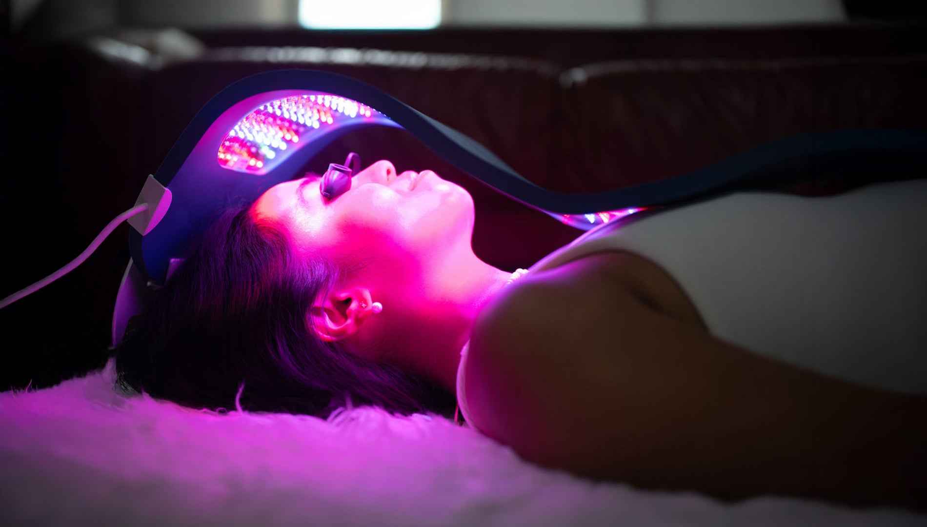 Person doing a Celluma LED red light therapy treatment for skin rejuvenation. 
